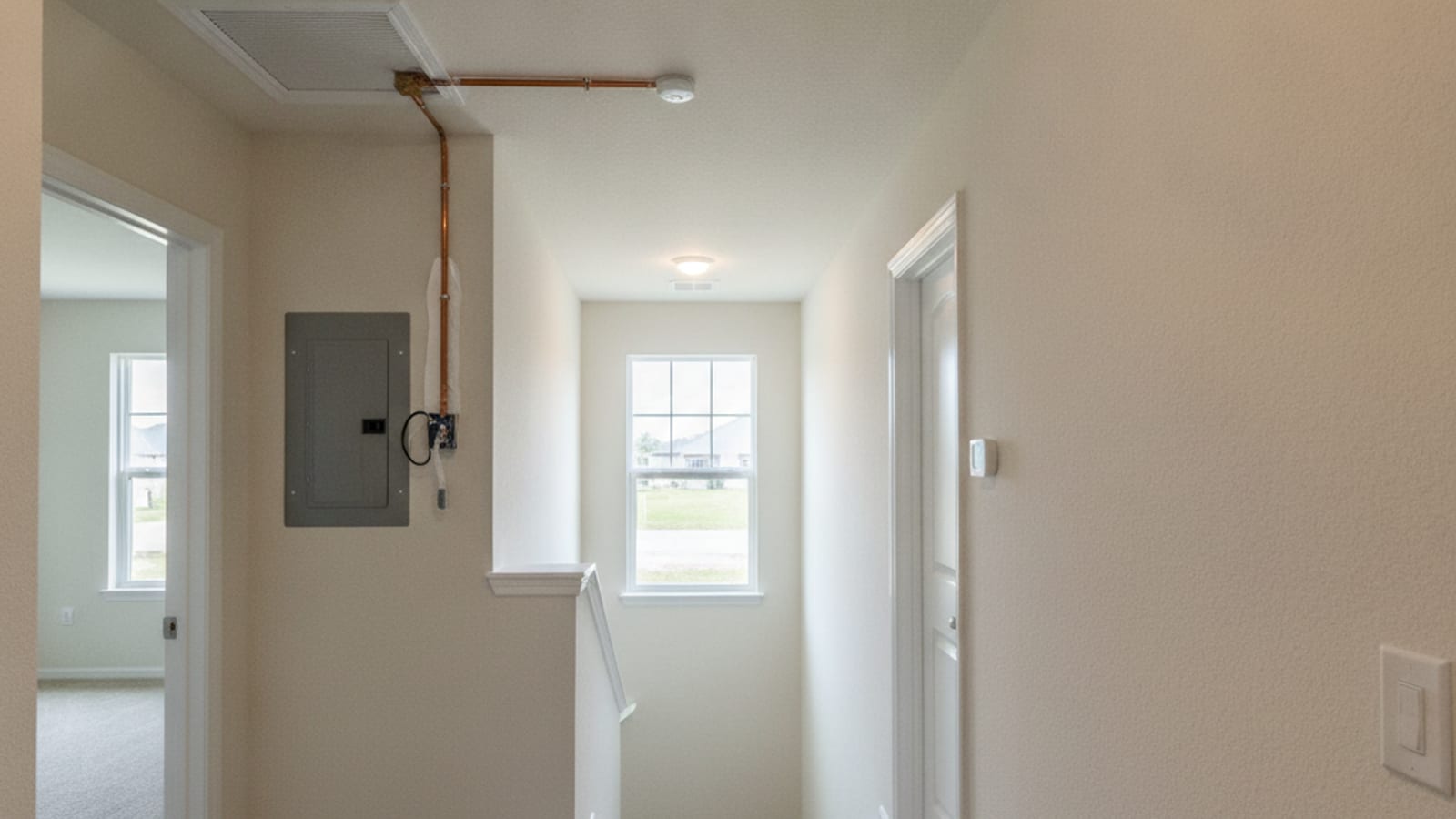 Upstairs hallway with a ceiling supply vent in a two story Pasco County production home